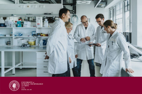 Team of scientist with digital tablet working together while standing at laboratory
